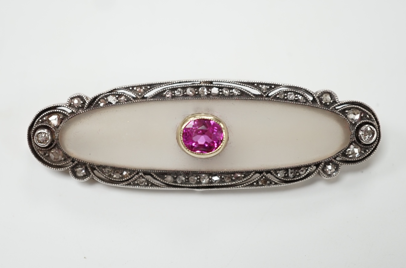 A 1920's yellow metal, diamond and single stone pink sapphire set rock crystal oval brooch, 48mm, gross weight 7.7 grams. Good condition.